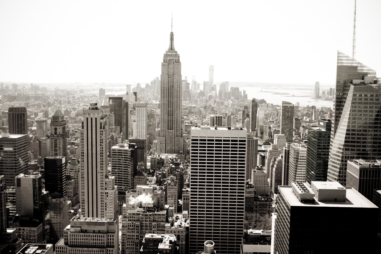 Aerial view of Manhattans iconic skyline featuring the Empire State Building in monochrome.